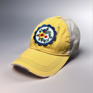 Product image of a yellow trucker hat with a flowers patch.